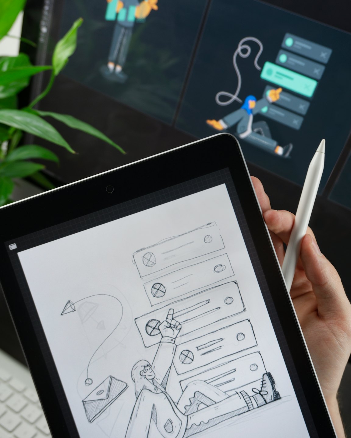 Hand holding tablet with UI sketch and character.